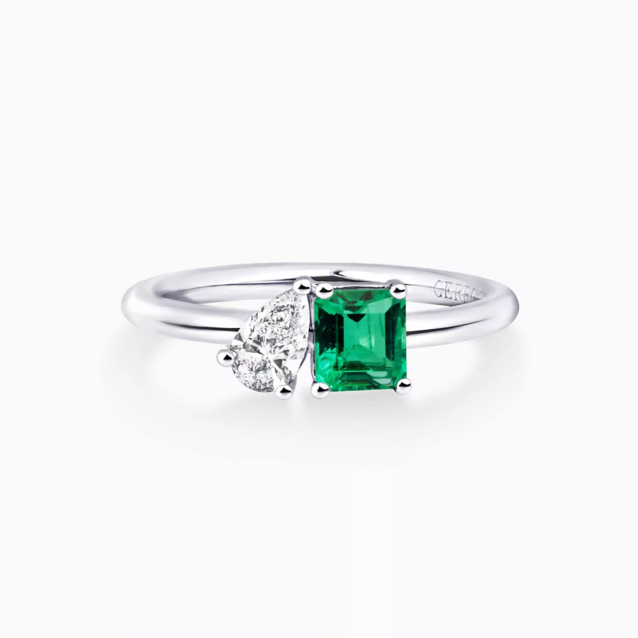 18ct white gold 0.48ct emerald cut emerald and 0.25ct pear shaped diamond ring