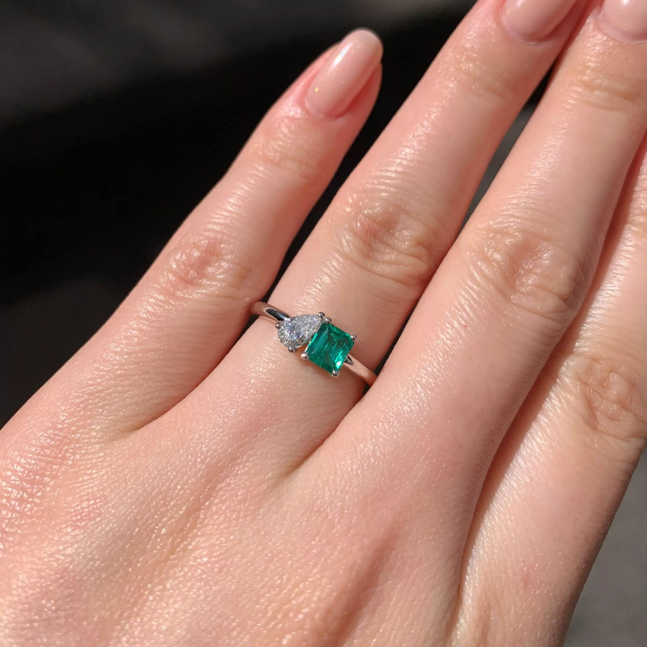 18ct white gold 0.48ct emerald cut emerald and 0.25ct pear shaped diamond ring