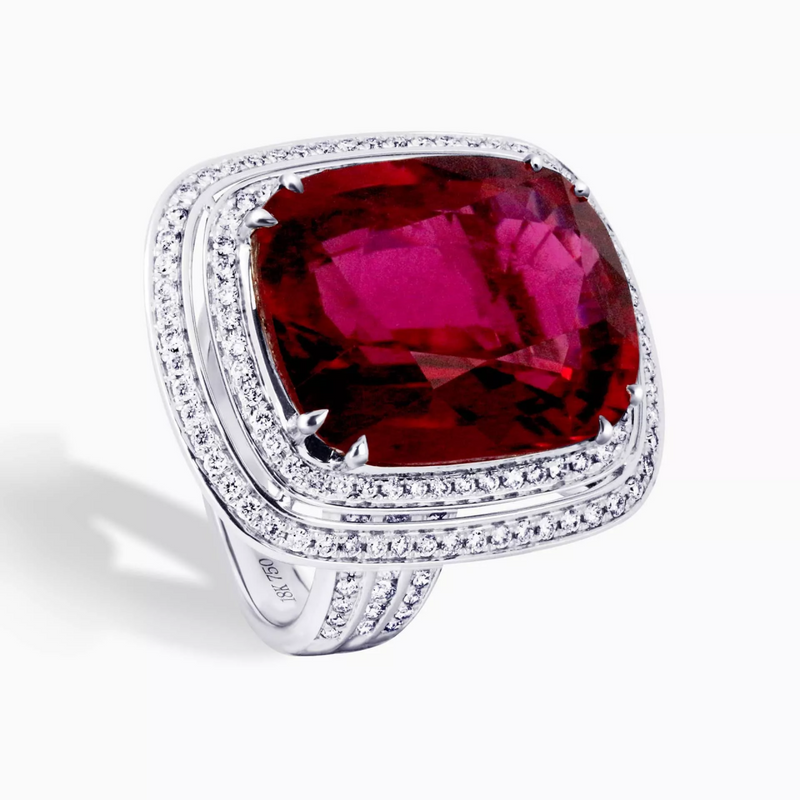 An 18ct white gold ring with a cushion cut tourmaline center stone and round brilliant cut diamond double halo