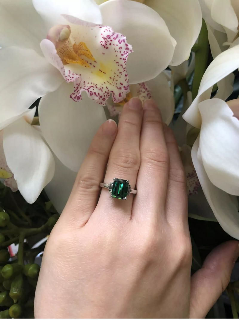18ct white gold tourmaline and baguette diamond ring on the finger