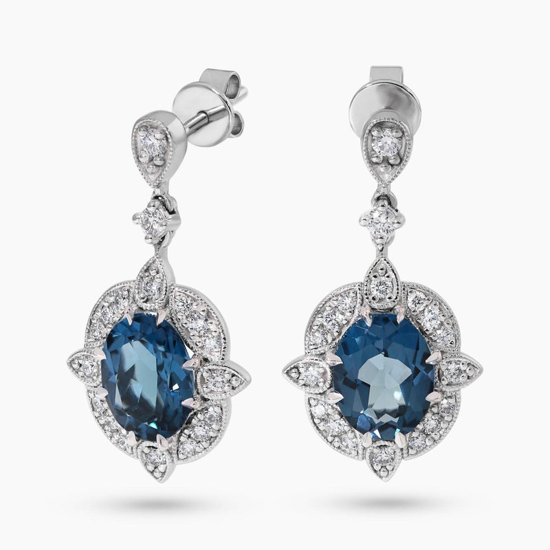 A pair of 18ct white gold oval London blue topaz and diamond drop earrings.