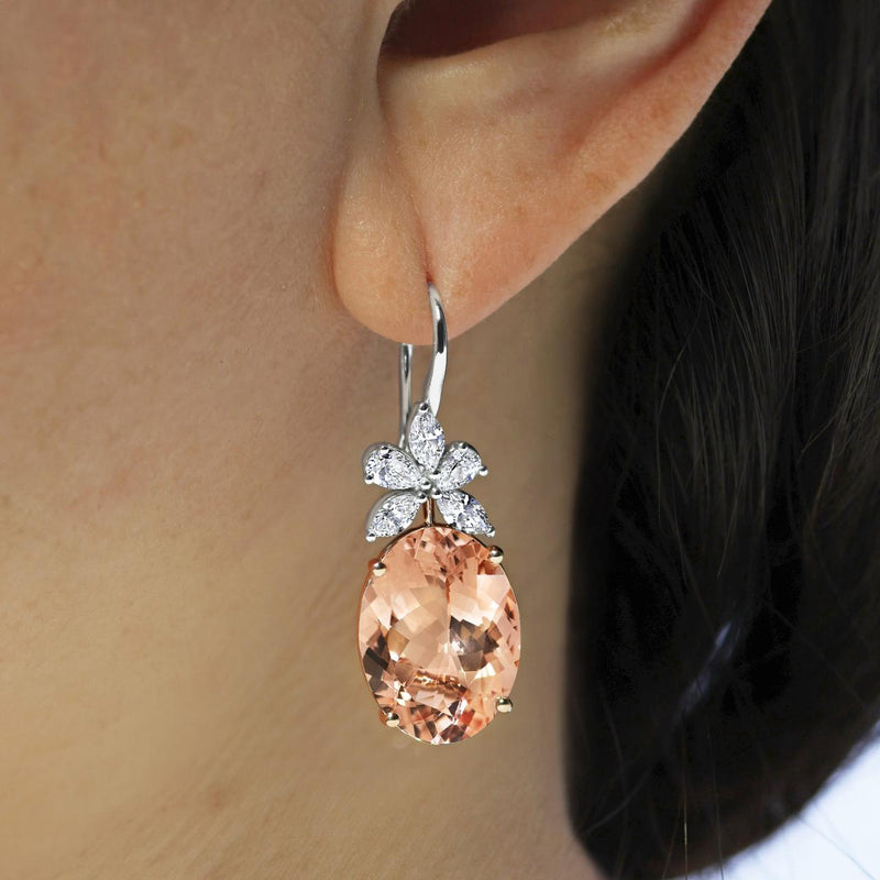 18ct rose and white gold oval morganite and marquise cut diamond drop earrings on the ear