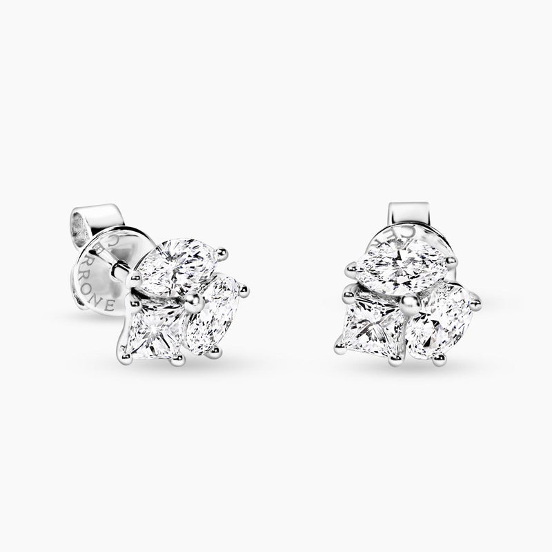 A pair of 18ct white gold stud earrings featuring marquise, princess, and oval cut diamonds.