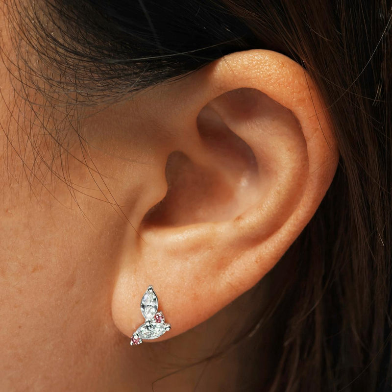 A pair of 18ct white gold marquise and round brilliant cut argyle pink diamond stud earrings on the ear