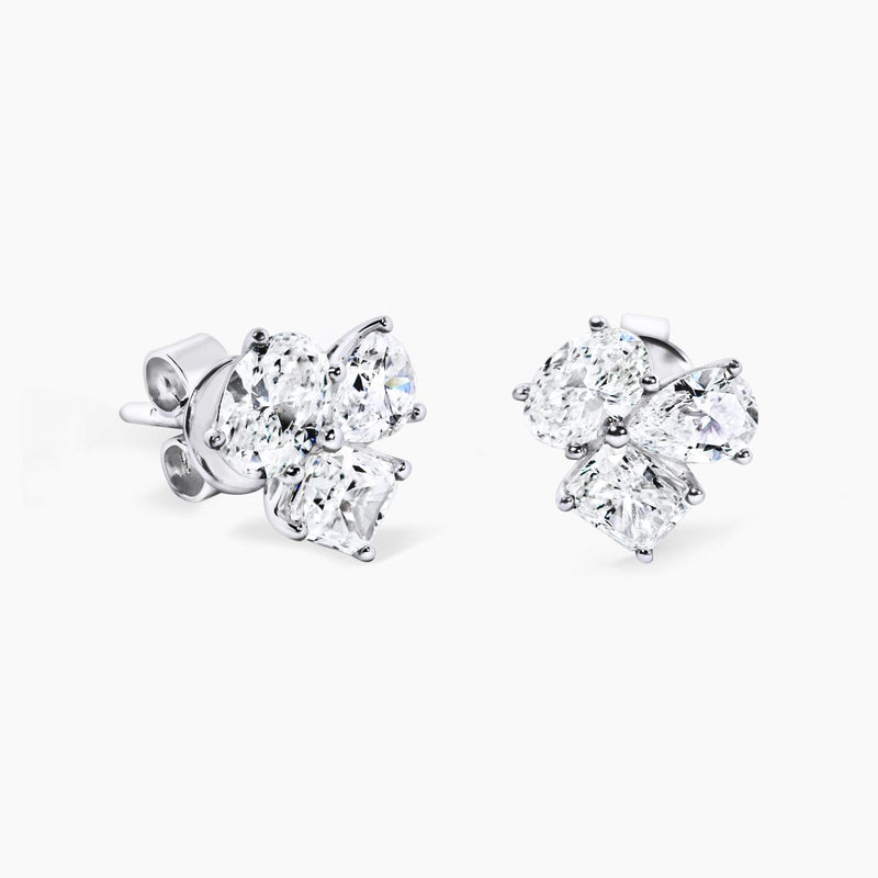 A pair of 18ct white gold radiant cut diamond stud earrings with pear and oval shaped diamonds in a claw setting.