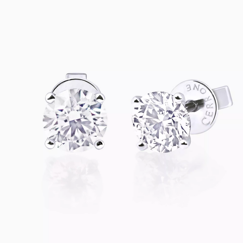 A pair of 18ct white gold diamond stud earrings with round brilliant cut diamonds in a four claw setting.