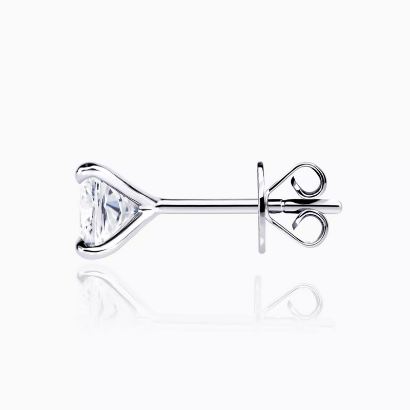 A pair of 18ct white gold cushion cut diamond stud earrings with a four claw setting side view