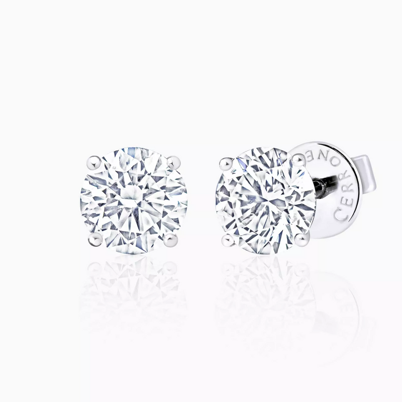 A pair of 18ct white gold diamond stud earrings with round brilliant cut diamonds in a four claw setting.