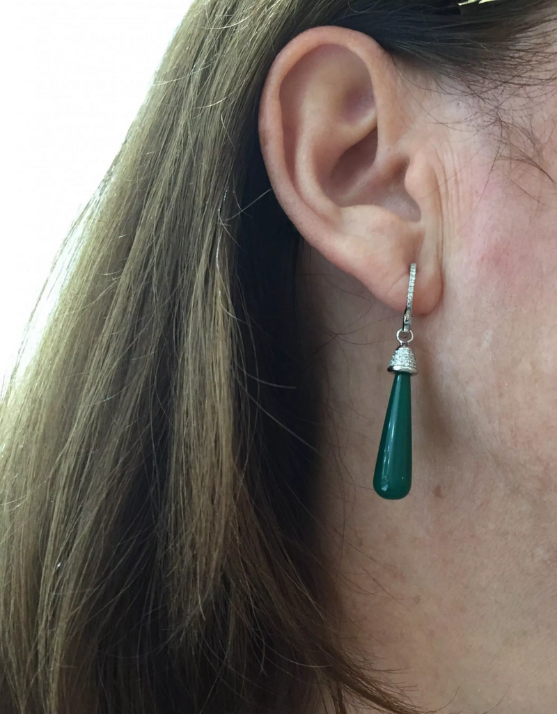 A pair of 18ct white gold green onyx diamond drop earrings with multiple round brilliant cut diamonds and a teardrop-shaped green onyx on the ear