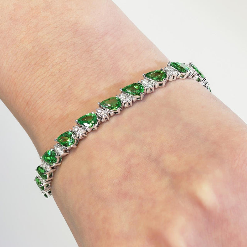 18ct white gold pear shaped tsavorite garnet and round diamond bracelet on the wrist