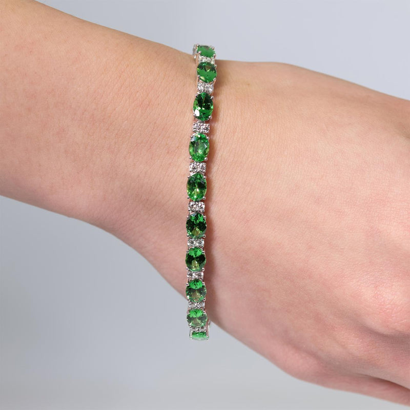18ct white gold oval Tsavorite garnet and round brilliant cut diamond bracelet on wrist