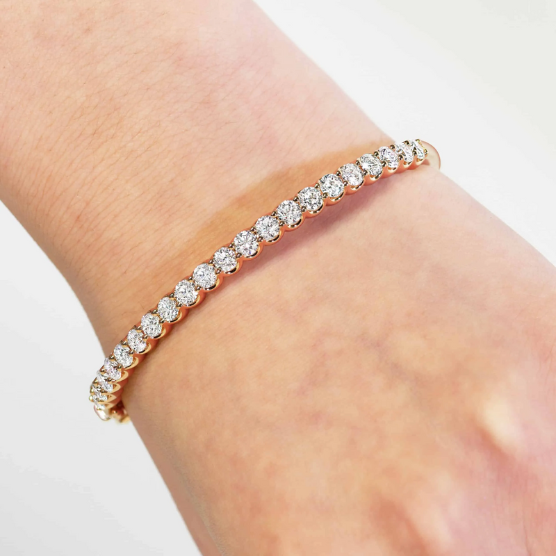 18ct rose gold claw set diamond hinged bangle on the wrist
