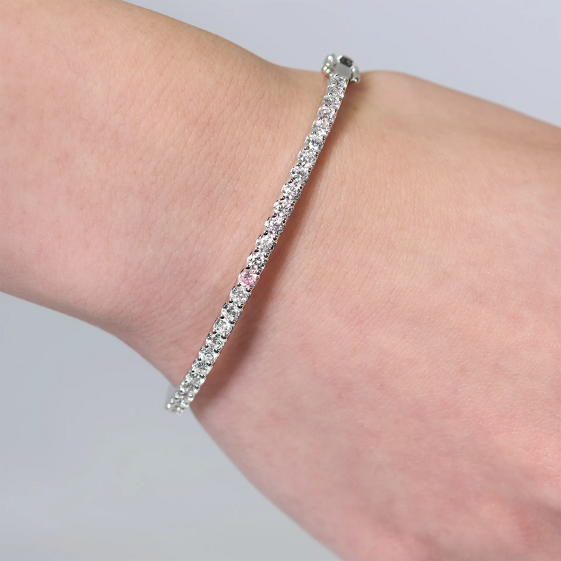 18ct white gold pink and white diamond hinged bangle on the wrist