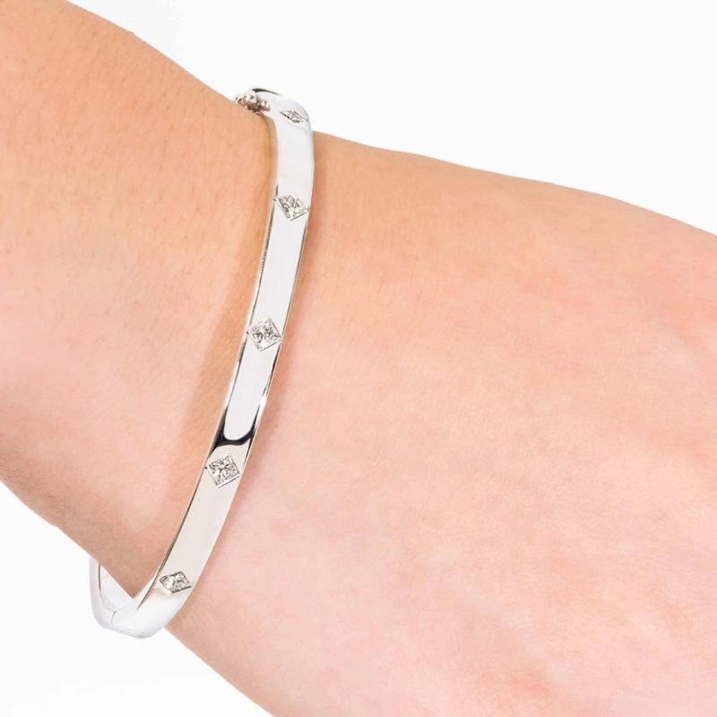 18ct white gold drop set princess cut diamond bangle on the wrist