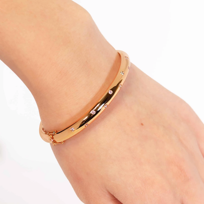 18ct rose gold round brilliant cut Argyle pink diamond hinged bangle on the wrist