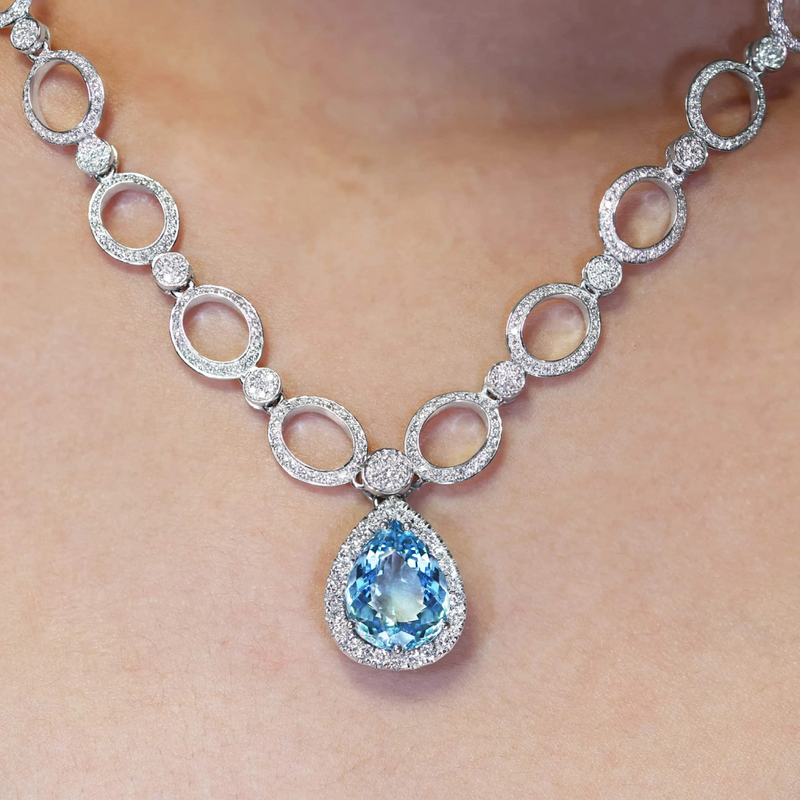 18ct white gold pear shaped aquamarine and diamond necklace on the neck