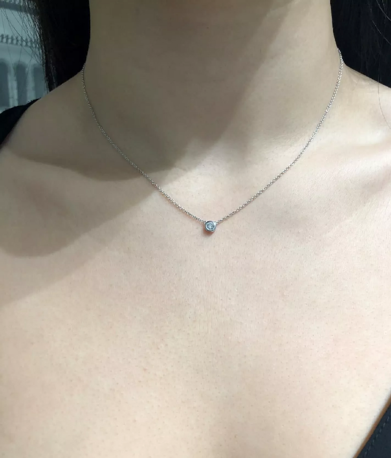 18ct white gold round diamond bezel set necklace on the neck