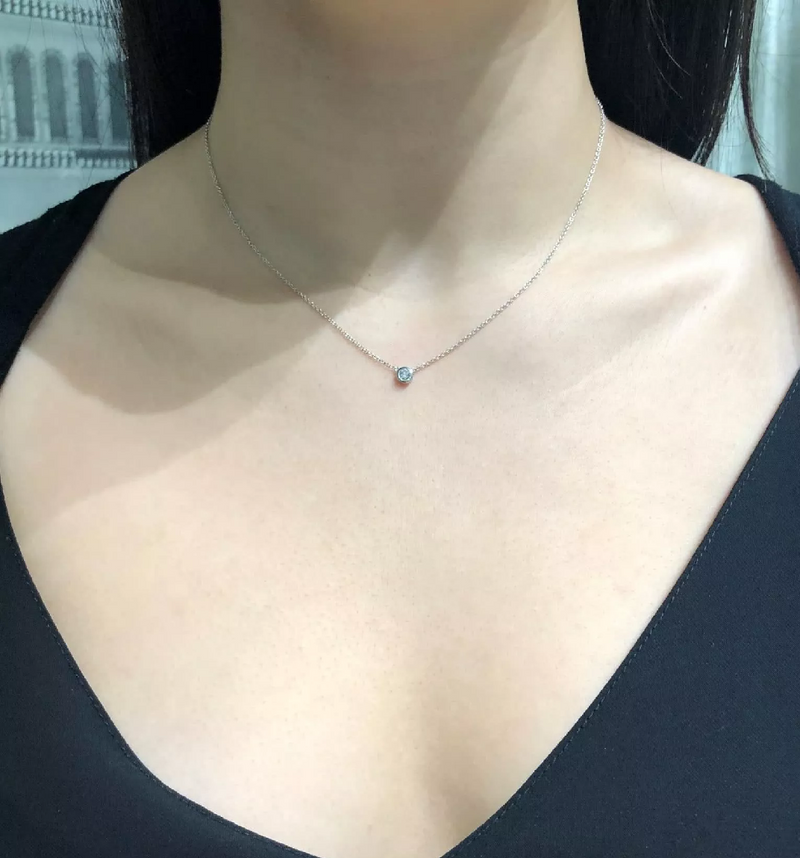 18ct white gold round diamond bezel set necklace on the neck