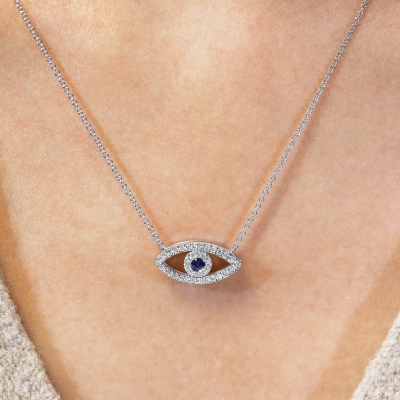 18ct white gold sapphire and diamond evil eye necklace on neck