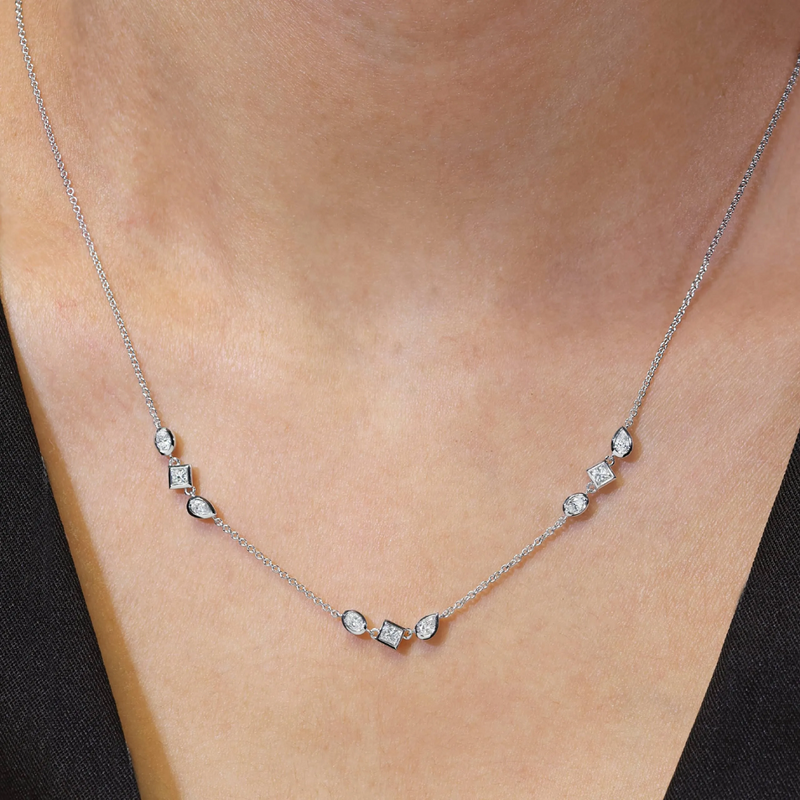 18ct white gold oval, pear, princess cut diamond bezel set necklace on the neck