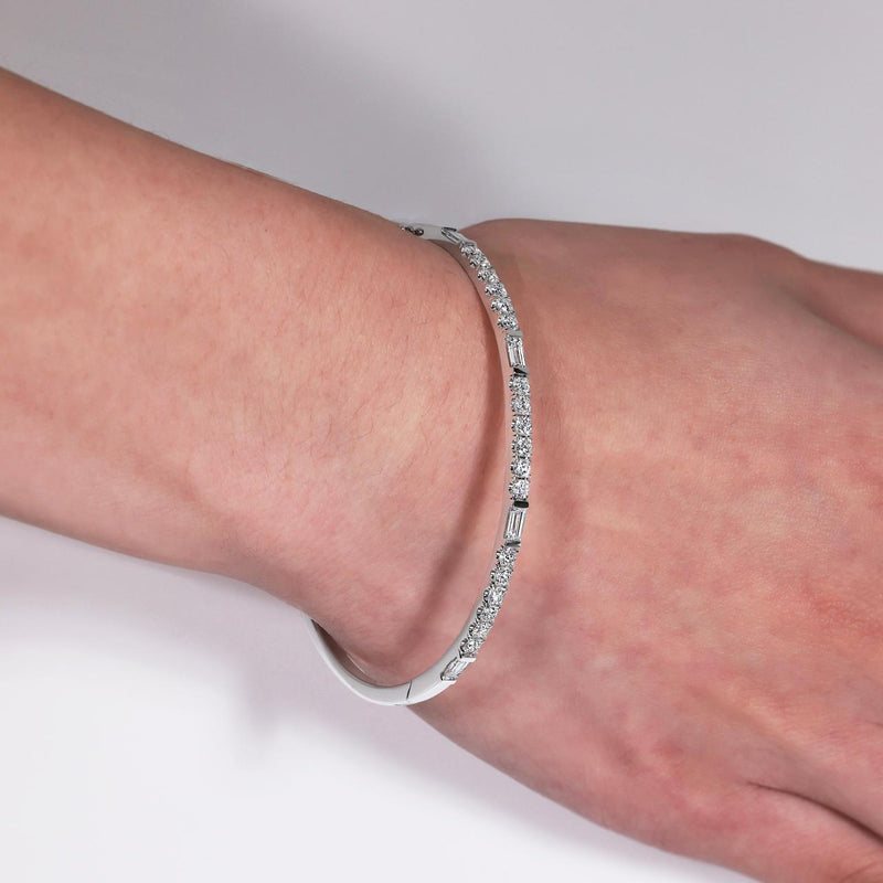 18ct white gold baguette and round diamond hinged bangle on the wrist