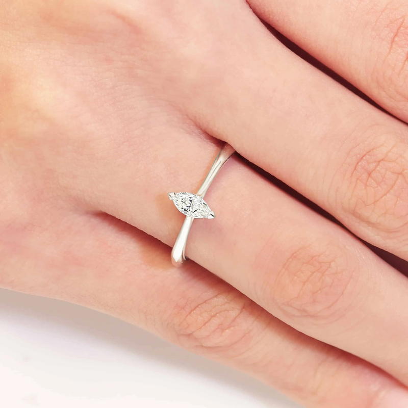 18ct white gold marquise cut diamond solitaire ring on finger