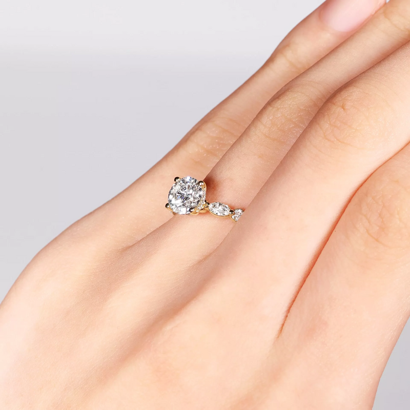 18ct yellow gold round brilliant and marquise cut diamond ring on finger