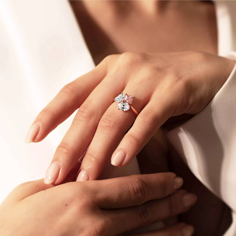 18ct rose gold Argyle princess cut pink diamond, oval and heart shaped white diamond ring on finger