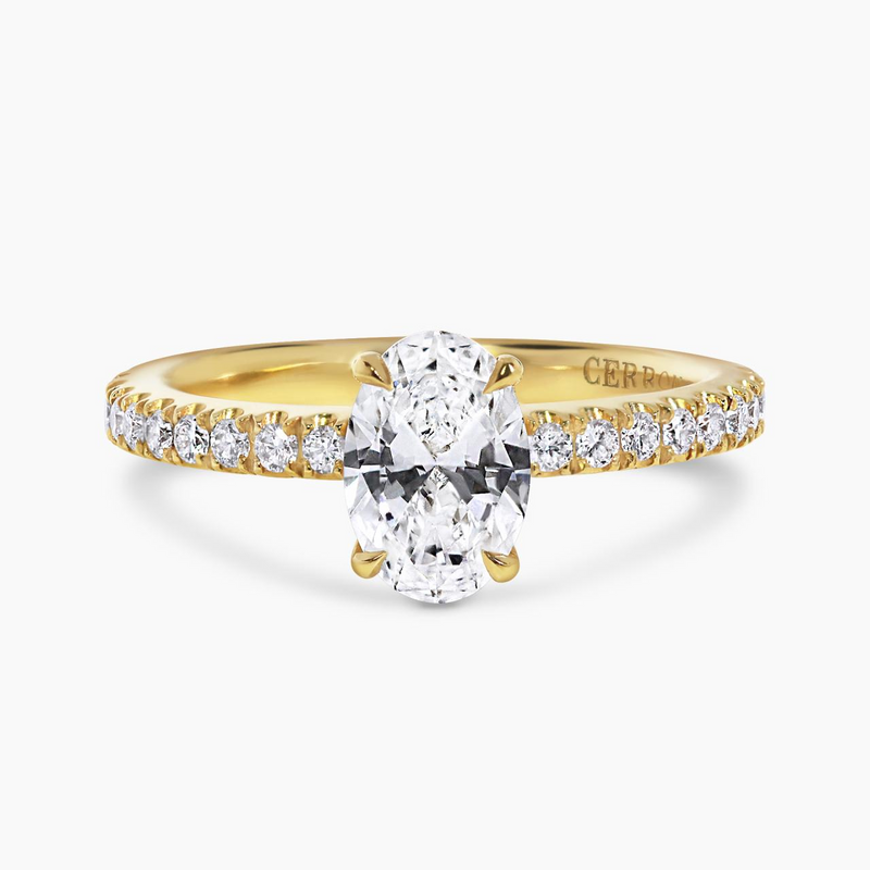 18ct yellow gold oval brilliant cut diamond with claw set hidden halo and diamond band