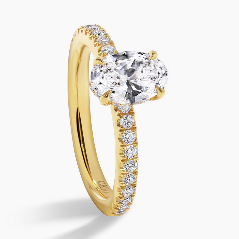 MILAN DIA - 18ct yellow gold oval brilliant cut diamond with claw set hidden halo and diamond band side profile