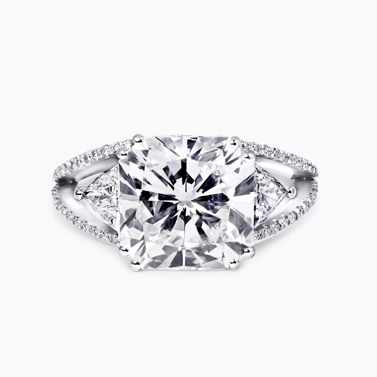 18ct white gold radiant and trilliant trilogy with round brilliant cut shaped halo ring