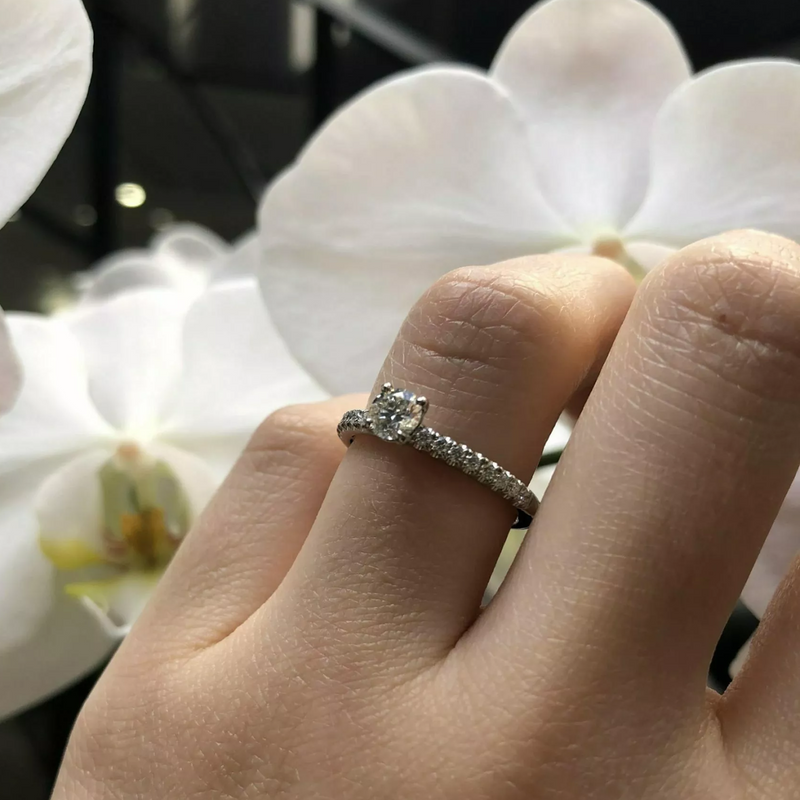 Platinum round brilliant cut diamond ring on finger