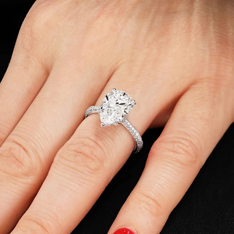18ct white gold 4.00ct pear and round brilliant cut diamond ring on finger