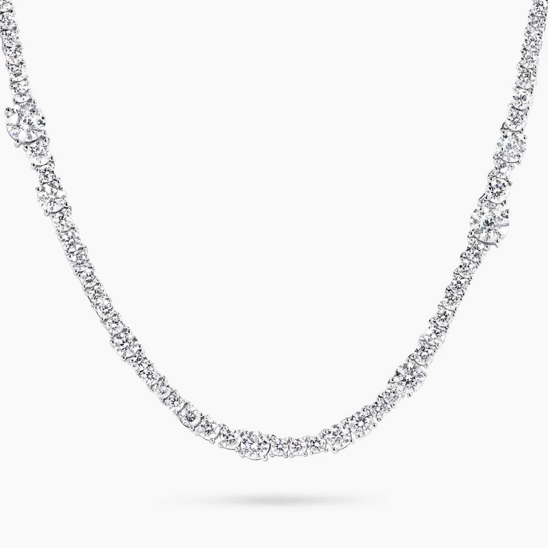An 18ct white gold diamond tennis necklace with round brilliant cut diamonds set in a four claw setting.