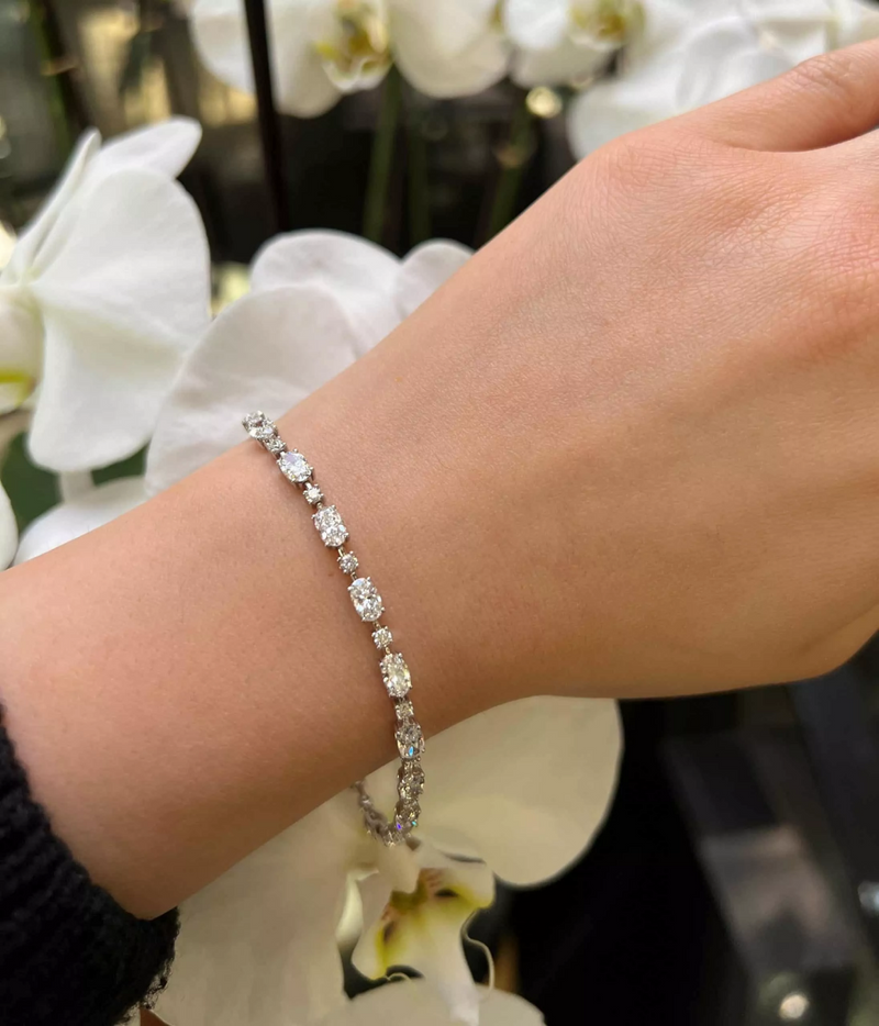 18ct white gold 6.57ct oval and round brilliant cut diamond tennis bracelet on the wrist