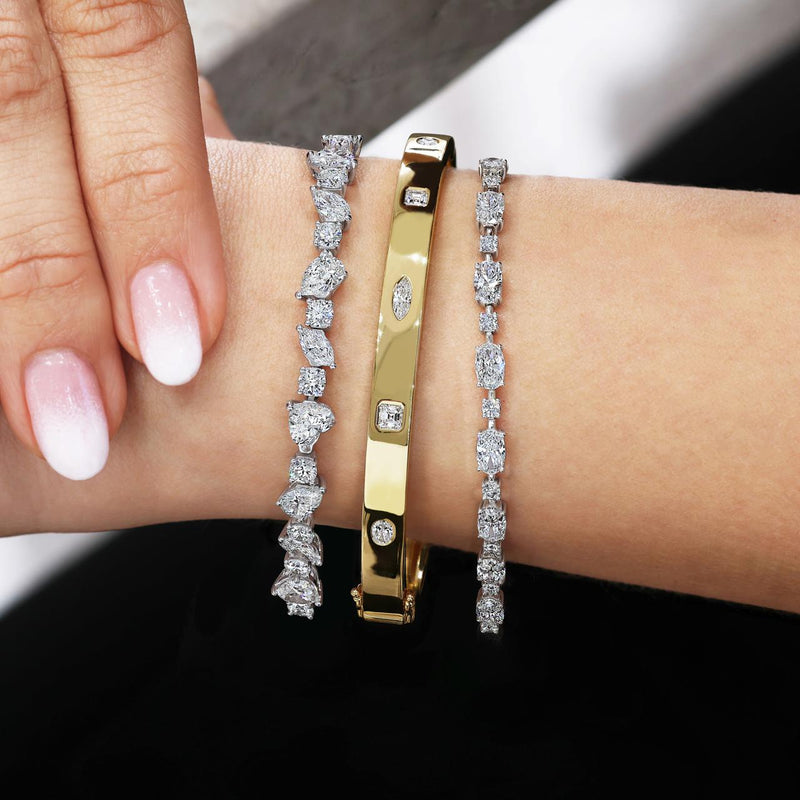 18ct white gold oval and round brilliant cut diamond tennis bracelet on the wrist