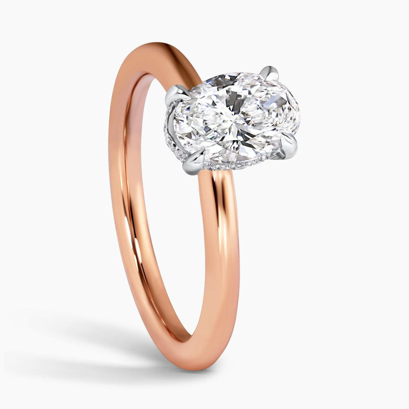 18ct rose and white gold oval brilliant cut diamond with round brilliant cut diamond hidden halo 