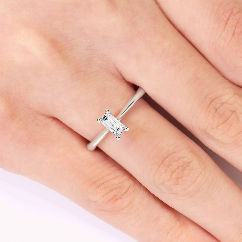 18ct white gold baguette cut diamond solitaire ring on finger