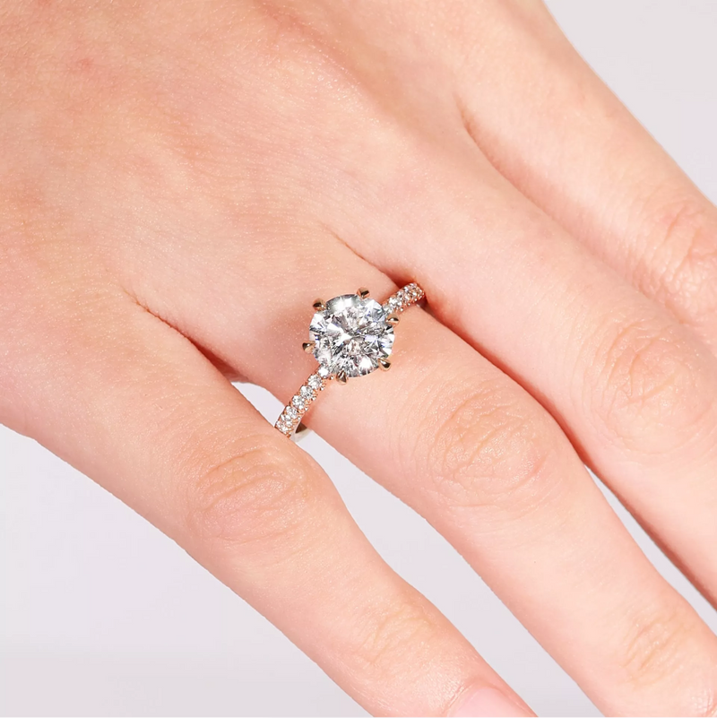18ct rose gold six claw round brilliant cut diamond ring on finger