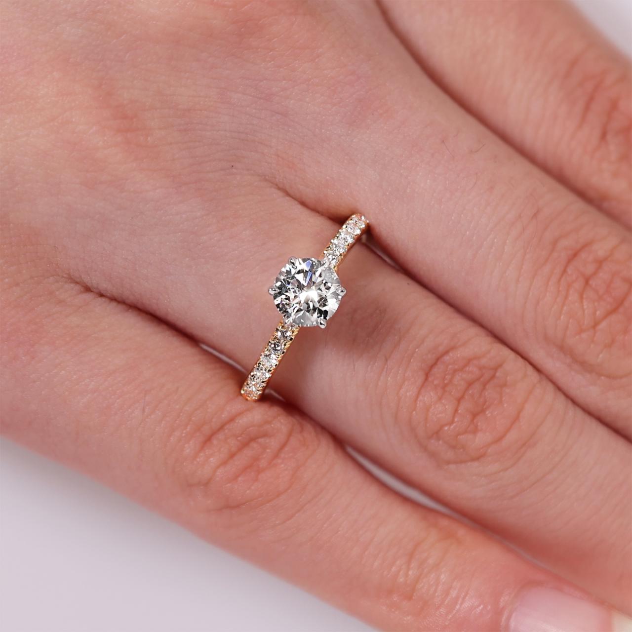 CAPRI DIA BAND - 18ct yellow and white gold round brilliant cut diamond ring in a six claw setting with diamond band on the finger