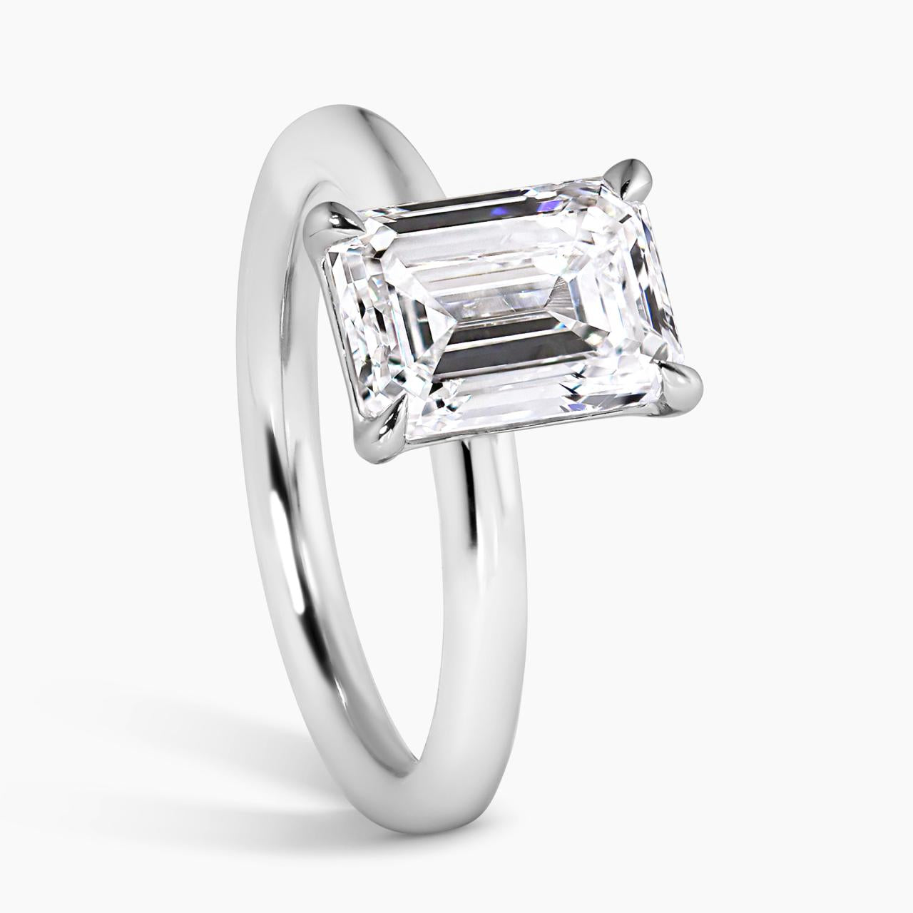 18ct white gold emerald cut diamond solitaire engagement ring in a four claw setting side view
