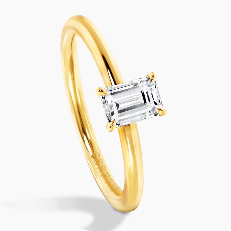 18ct yellow gold 0.50ct emerald cut solitaire ring in a four claw setting side view