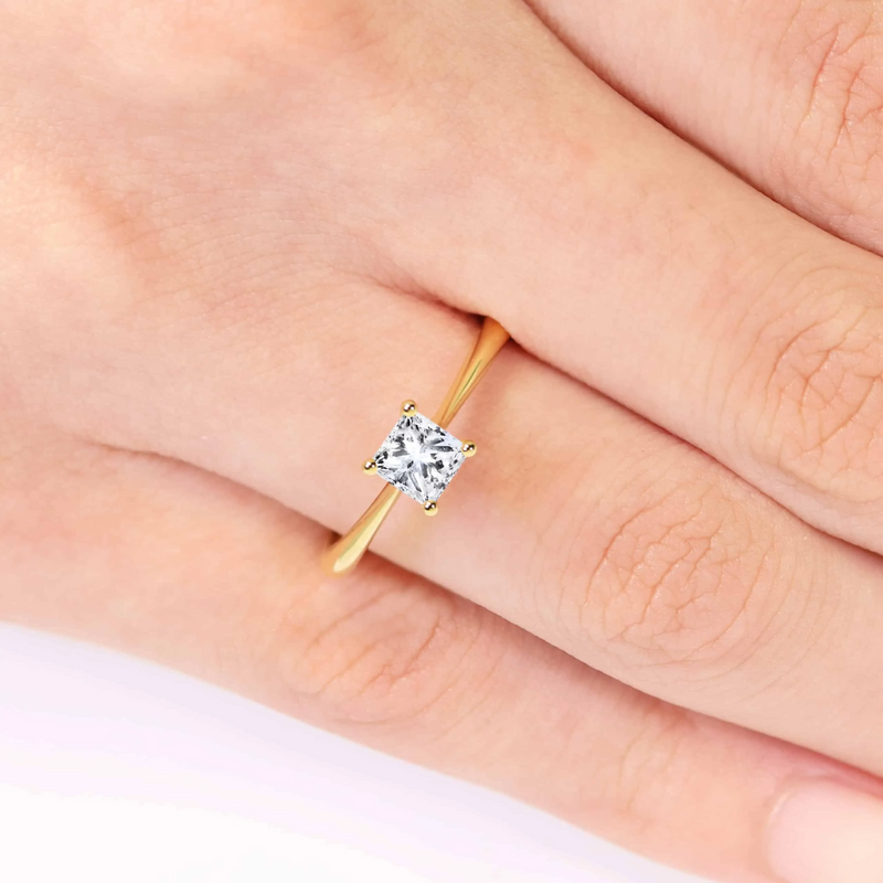 18ct yellow gold cushion cut four claw side v setting diamond ring on finger
