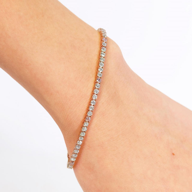 An 18ct rose gold tennis bracelet with argyle pink and round brilliant cut diamonds in a four claw setting on the wrist