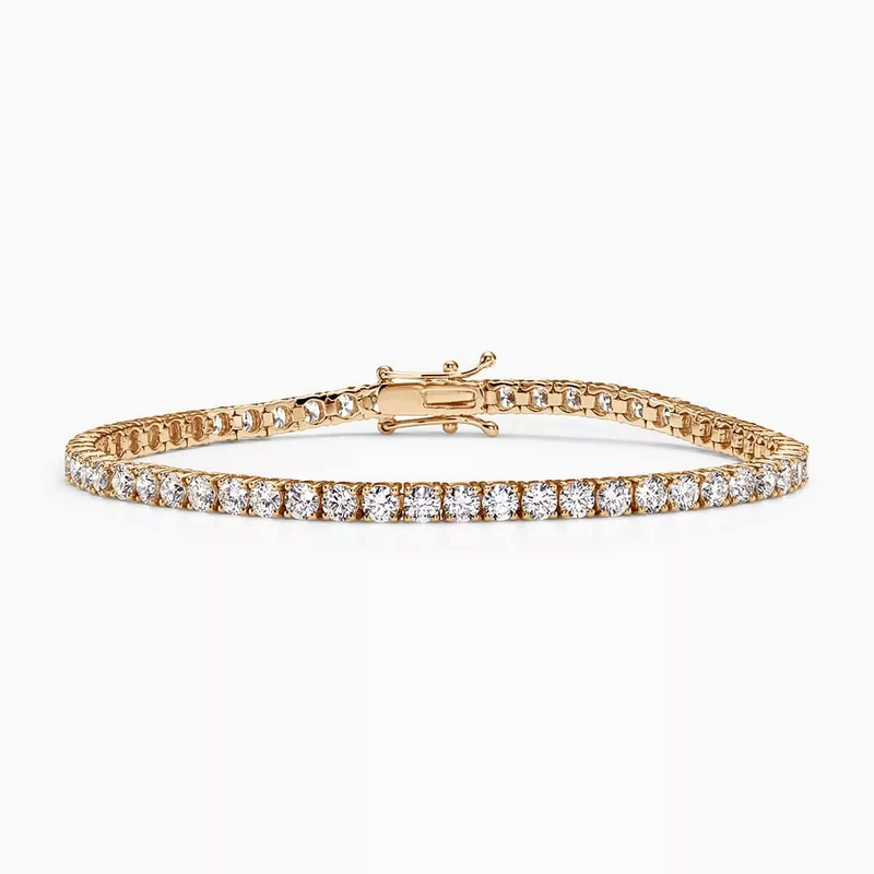 An 18ct rose gold diamond tennis bracelet with round brilliant cut diamonds in a four claw setting.