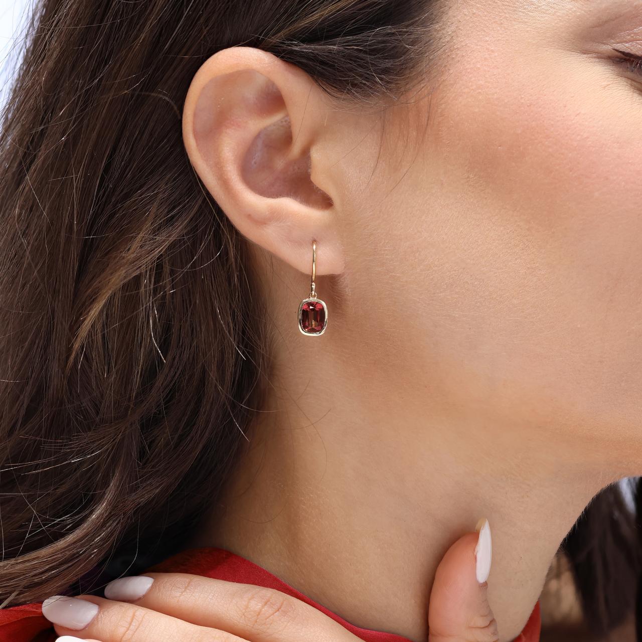 18ct yellow gold 2=3.71ct elongated cushion cut garnet bezel set drop earrings on the ear