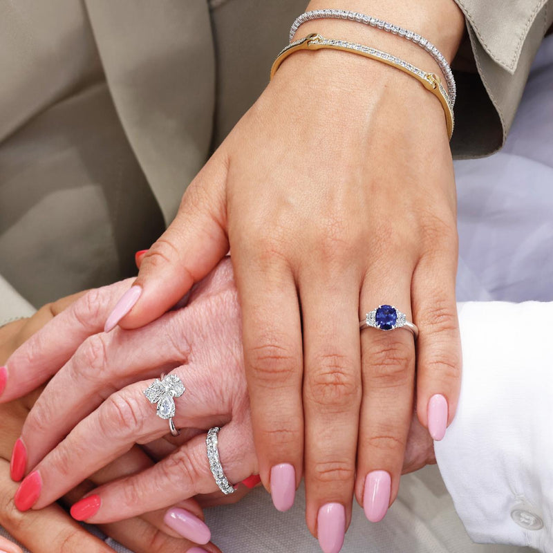 Platinum oval brilliant royal blue sapphire and diamond ring on the finger