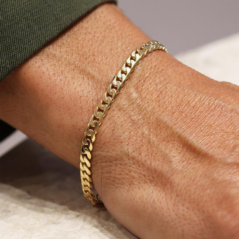 18ct yellow gold 21cm flat curb link solid bracelet on the wrist