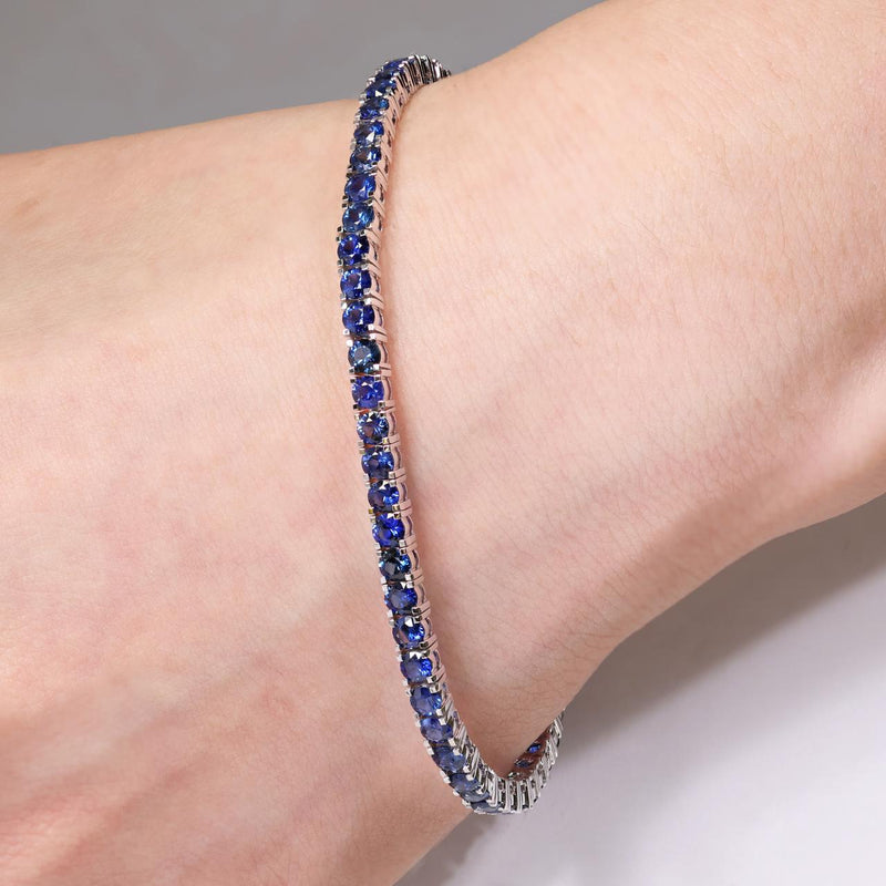 18ct white gold 5.49ct round blue sapphire bracelet on the wrist