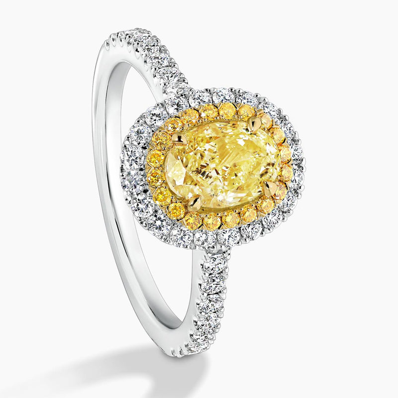 Platinum and 18ct yellow gold 1.04ct Fancy Intense Yellow oval and round diamond double halo ring